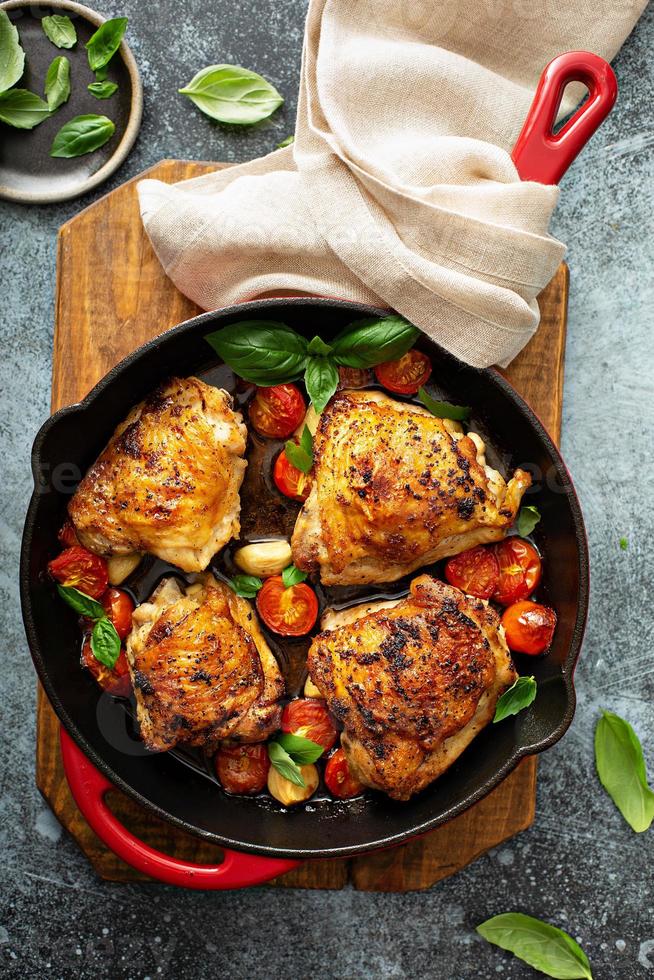 Chicken thighs roasted with tomatoes and garlic photo