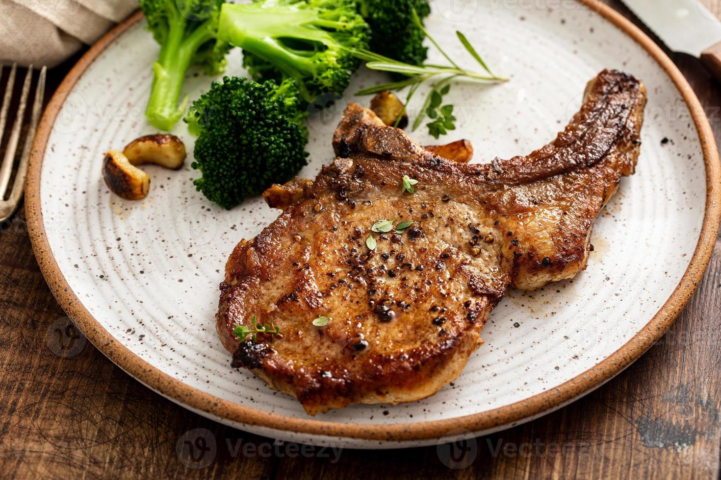 Grilled or pan fried pork chops on the bone photo