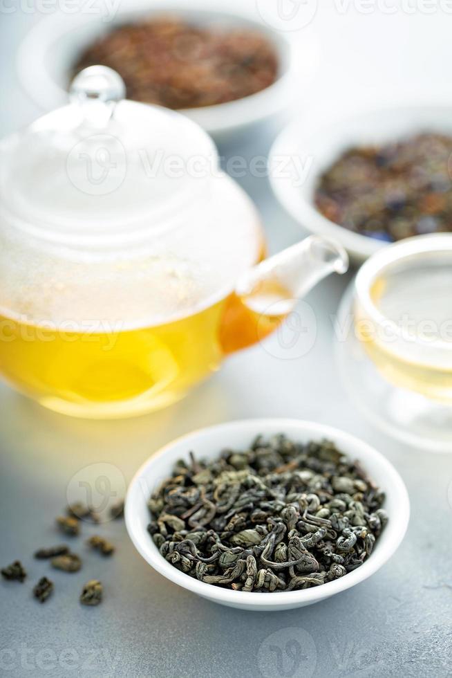 Green loose leaf tea and a teapot 16218206 Stock Photo at Vecteezy