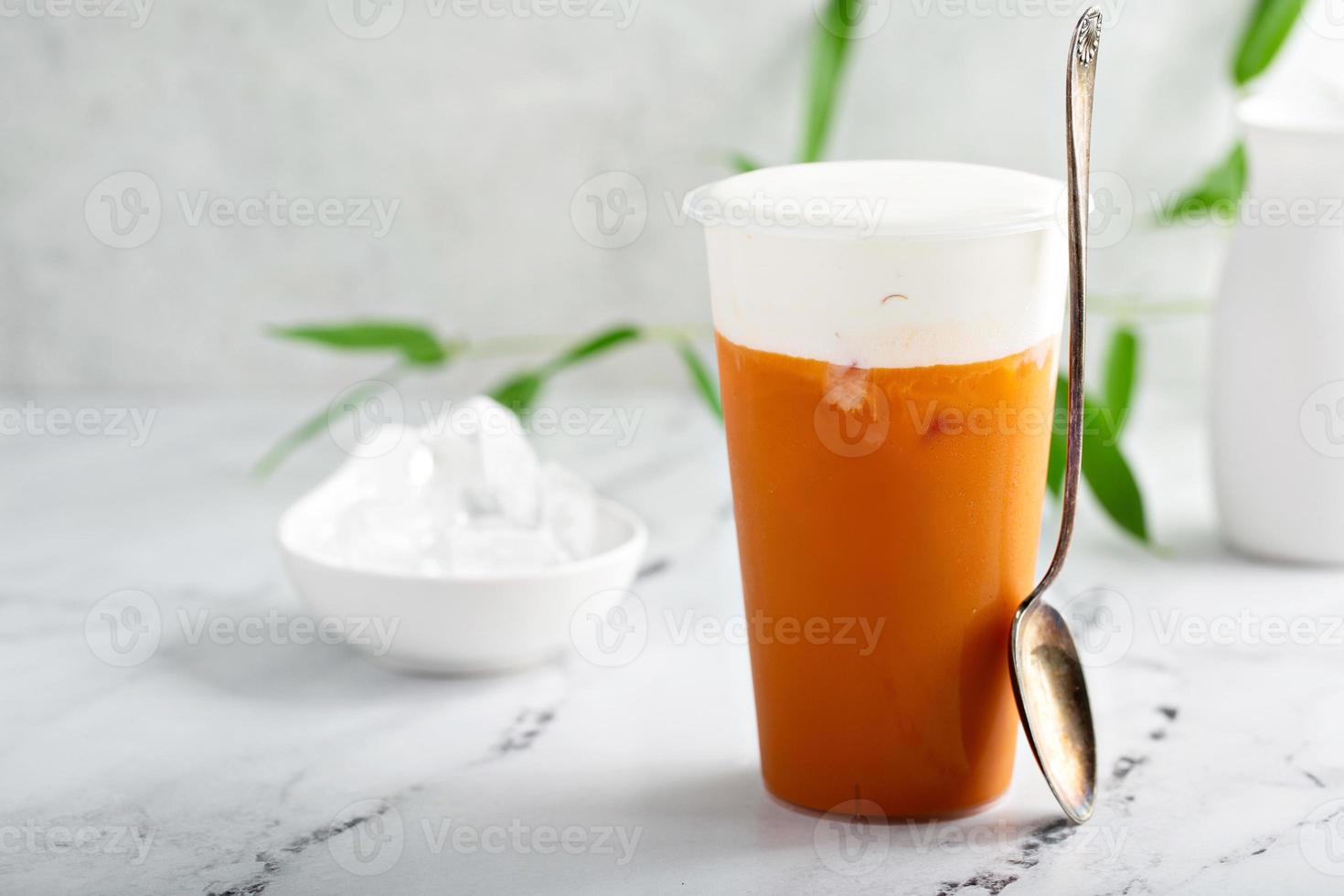Refreshing mango drink topped with creamy topping photo