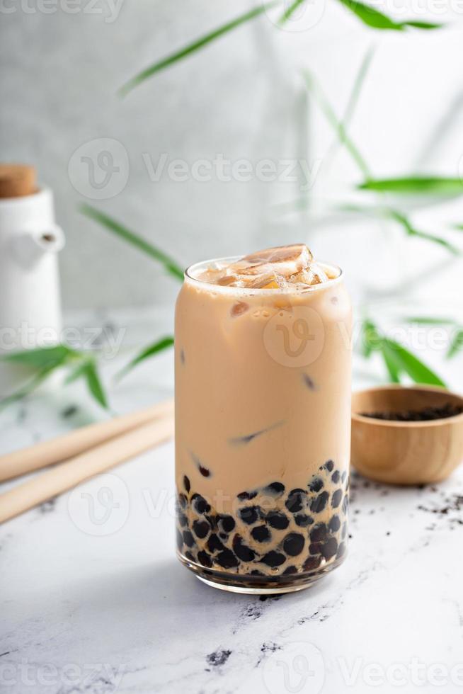 Boba milk tea in a tall glass with ice photo