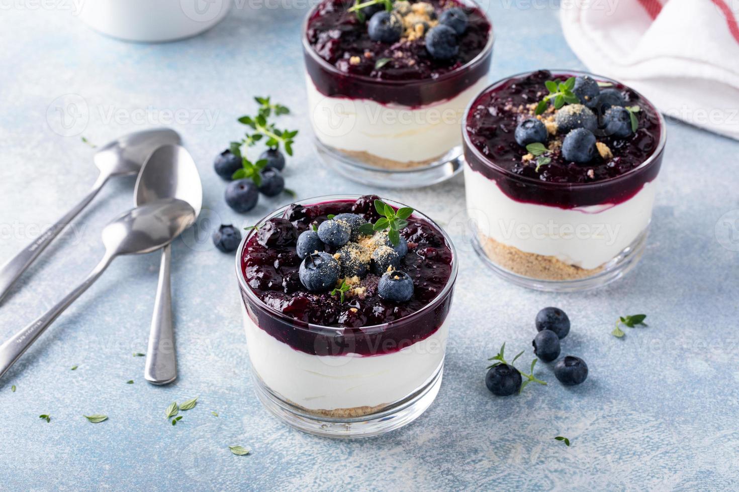 Blueberry cheesecake in a jar with graham cracker base photo