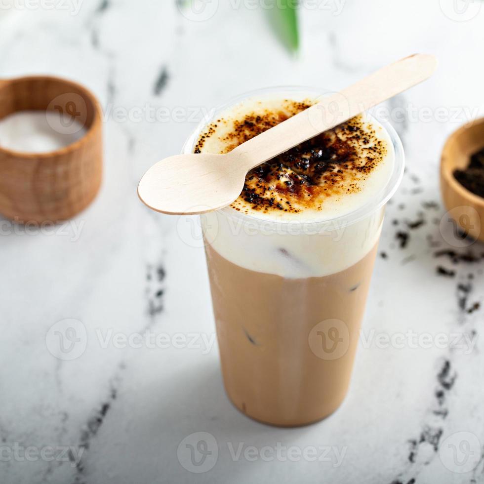 Creme bruleed iced coffee or tea with milk foam topping photo