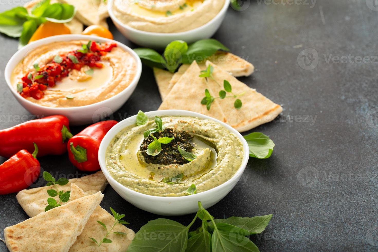 Hummus board with pita and different kinds of hummus photo