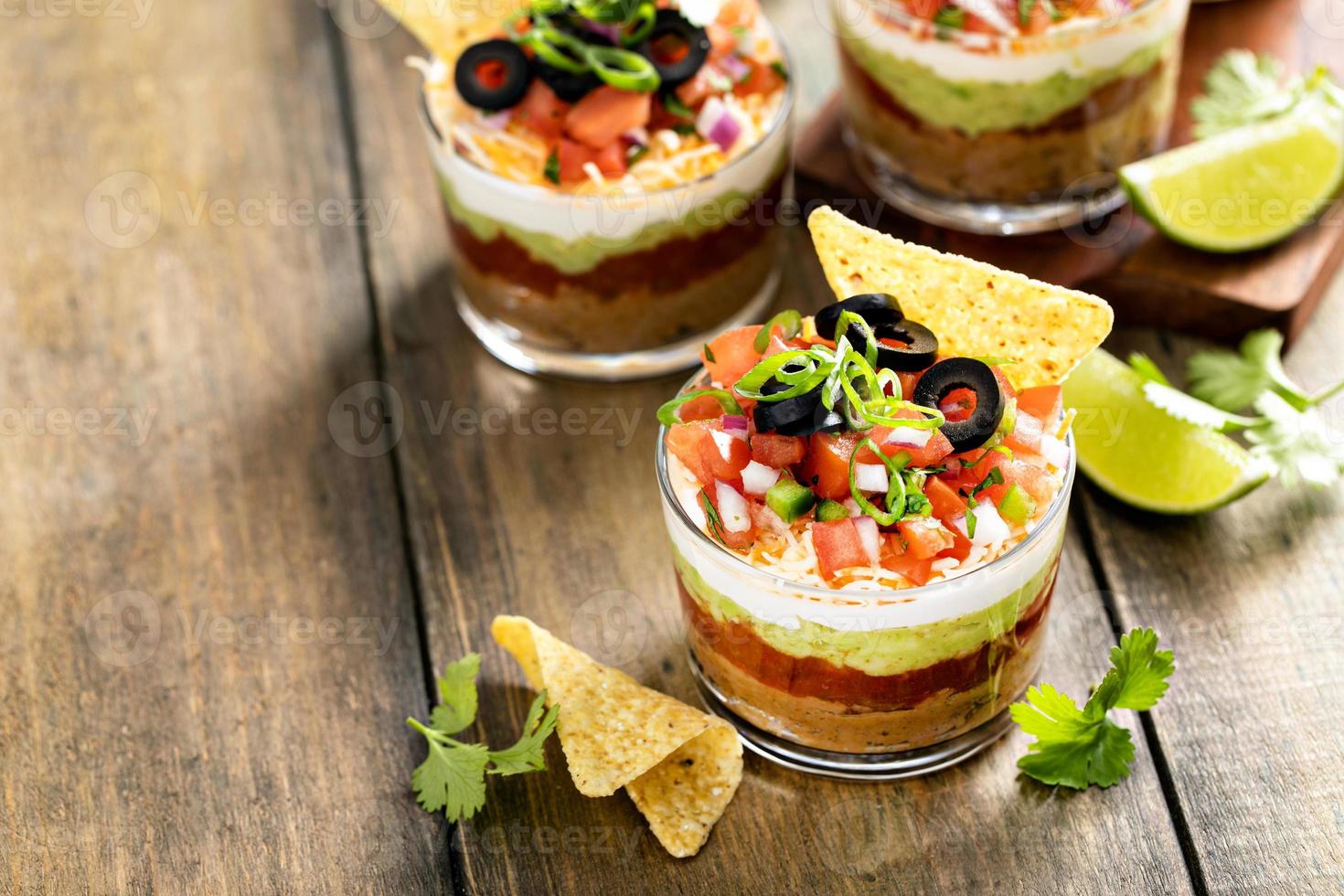 Seven layer dip in individual cups, mexican appetizer photo