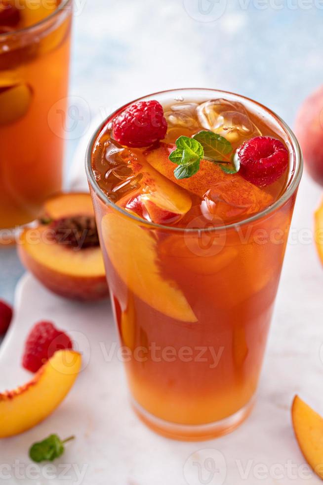 Peach and raspberry iced tea or cocktail photo
