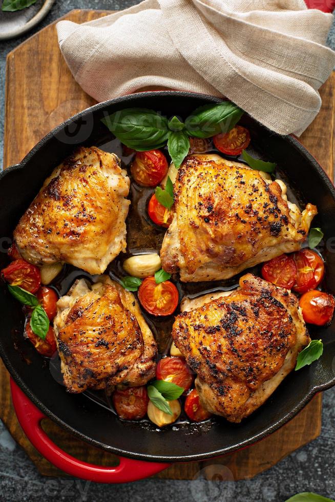 Chicken thighs roasted with tomatoes and garlic photo