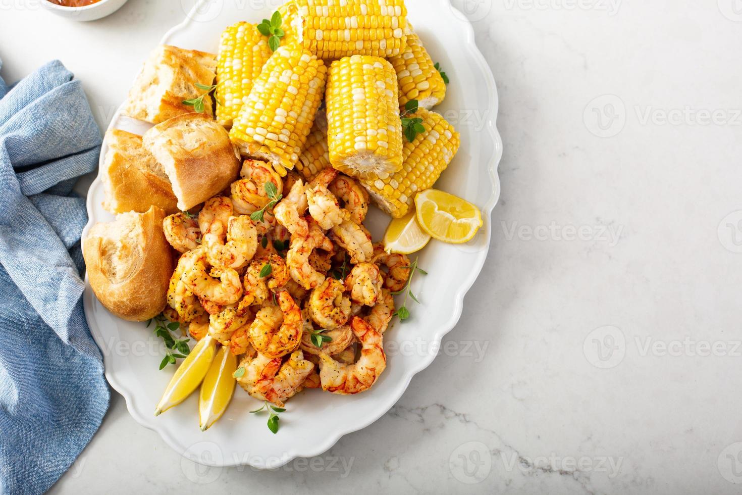 Fried shrimp and corn on the cob photo