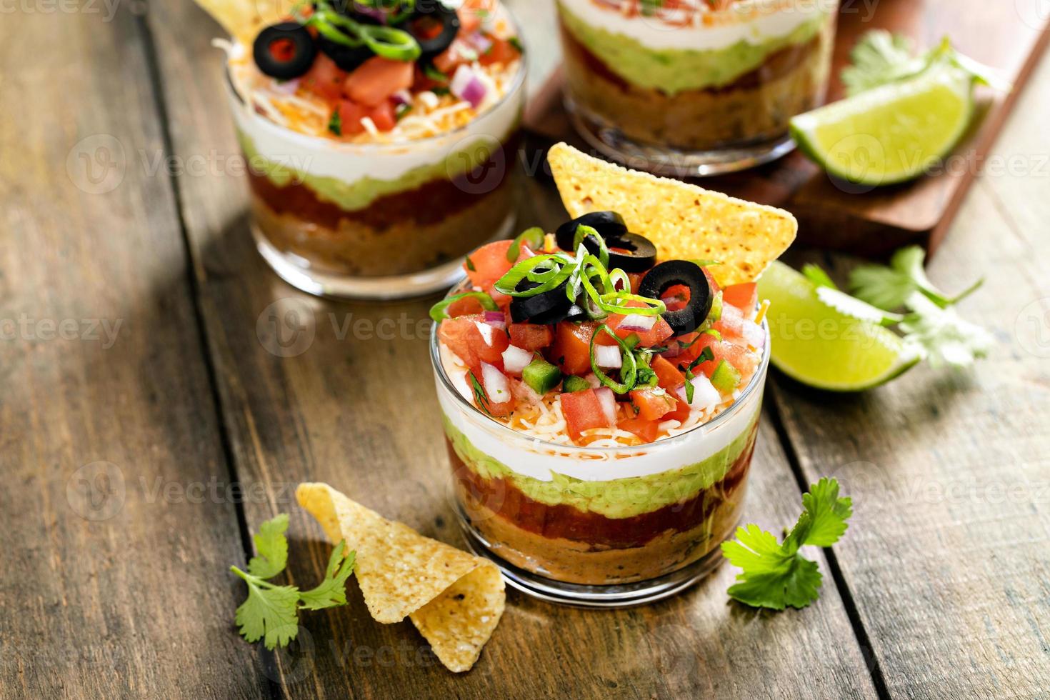 Seven layer dip in individual cups, mexican appetizer photo