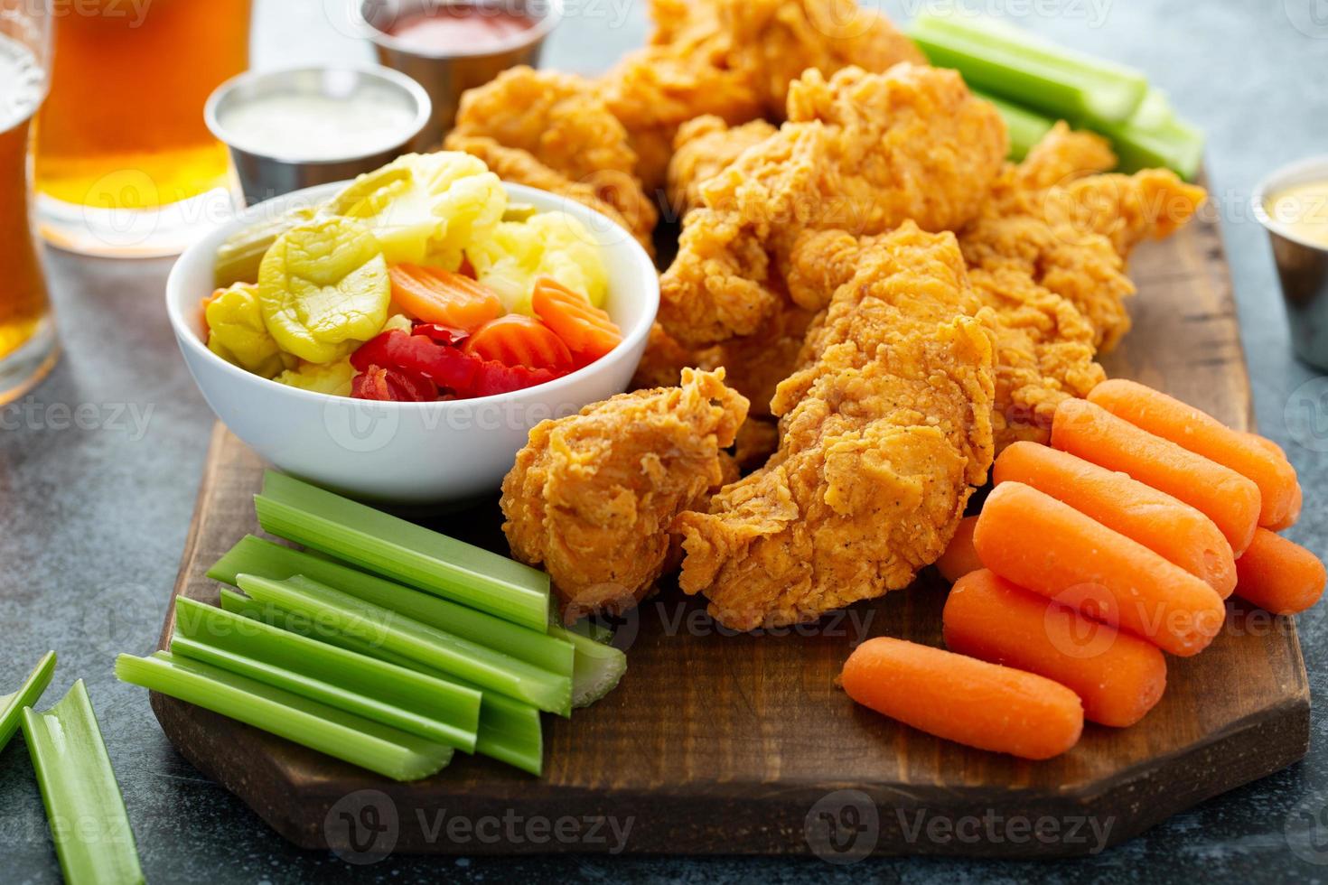 Fried chicken tenders with veggies photo