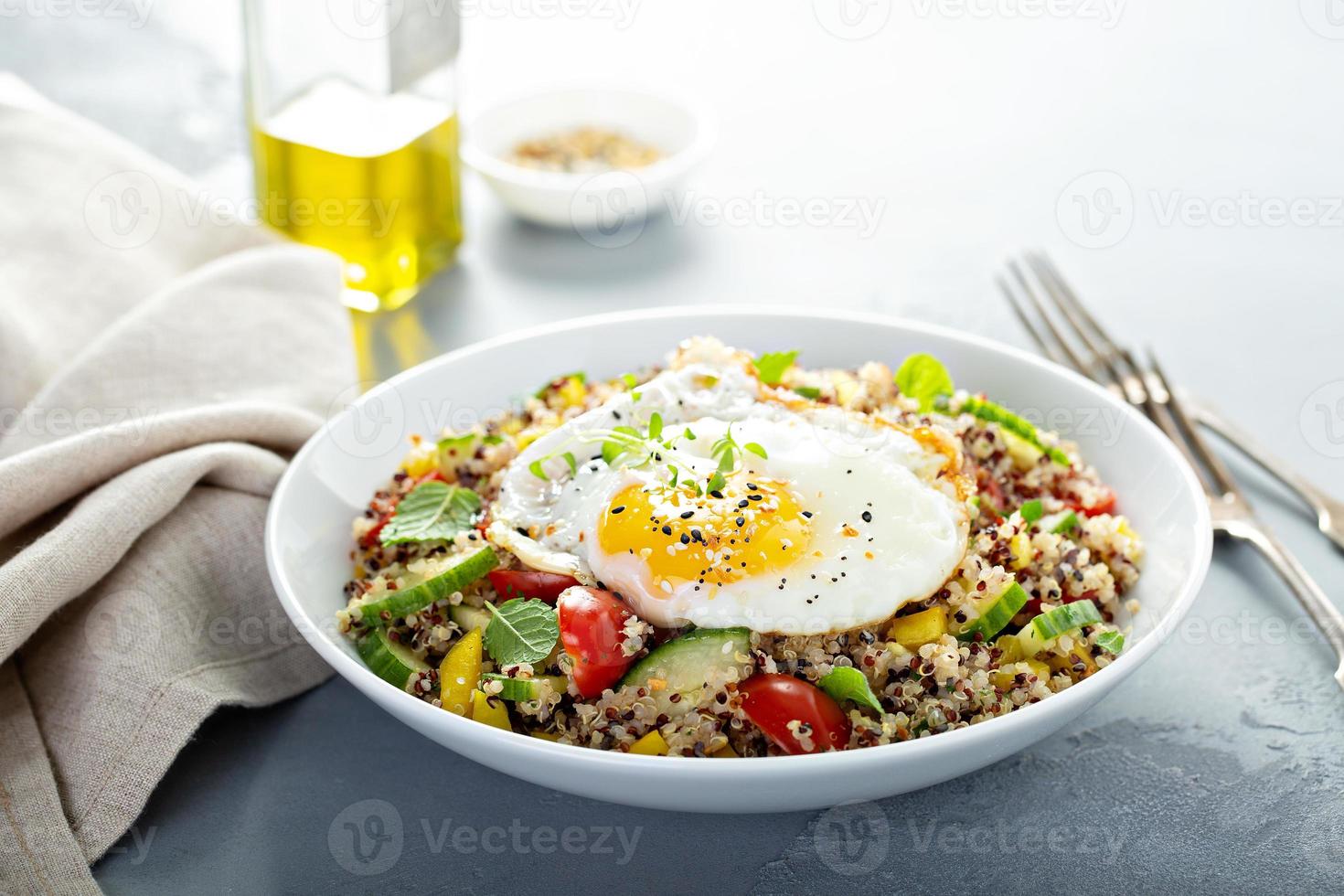 Fresh quinoa tabbouleh salad with fried egg photo