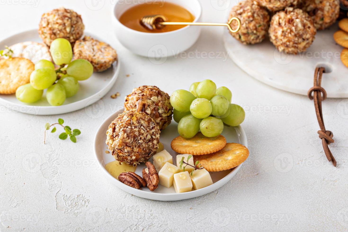 Cheese balls or truffles on a cheese board with crackers photo