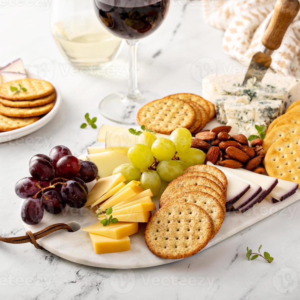 Cheese board with crackers, nuts and grapes photo