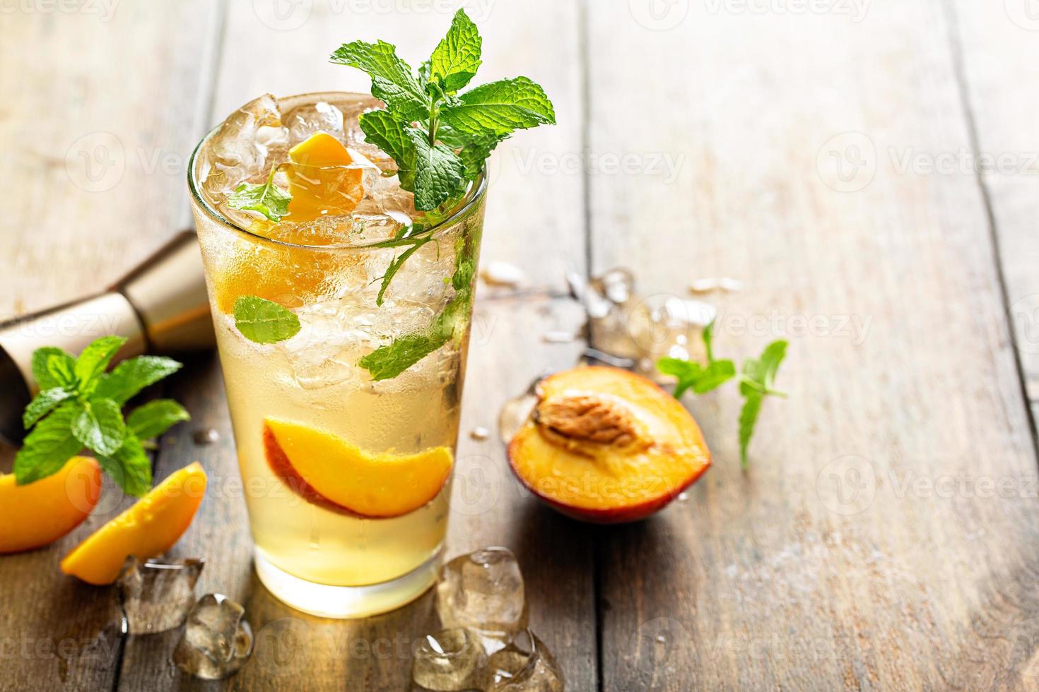 Summer peach mojito cocktail with fresh mint, lime and peach slices photo