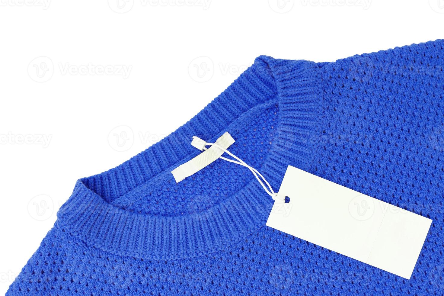 White blank rectangular clothing tag on blue knitted sweater isolated on white background photo