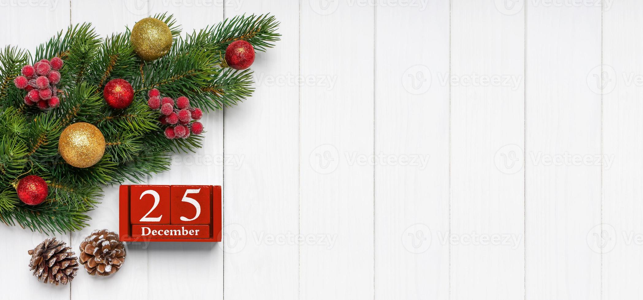 New Year background with decorated fir tree and red perpetual calendar of cubes photo