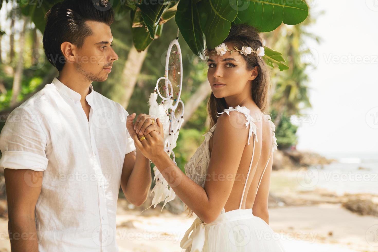 Just married couple is celebrating their wedding on the beach photo