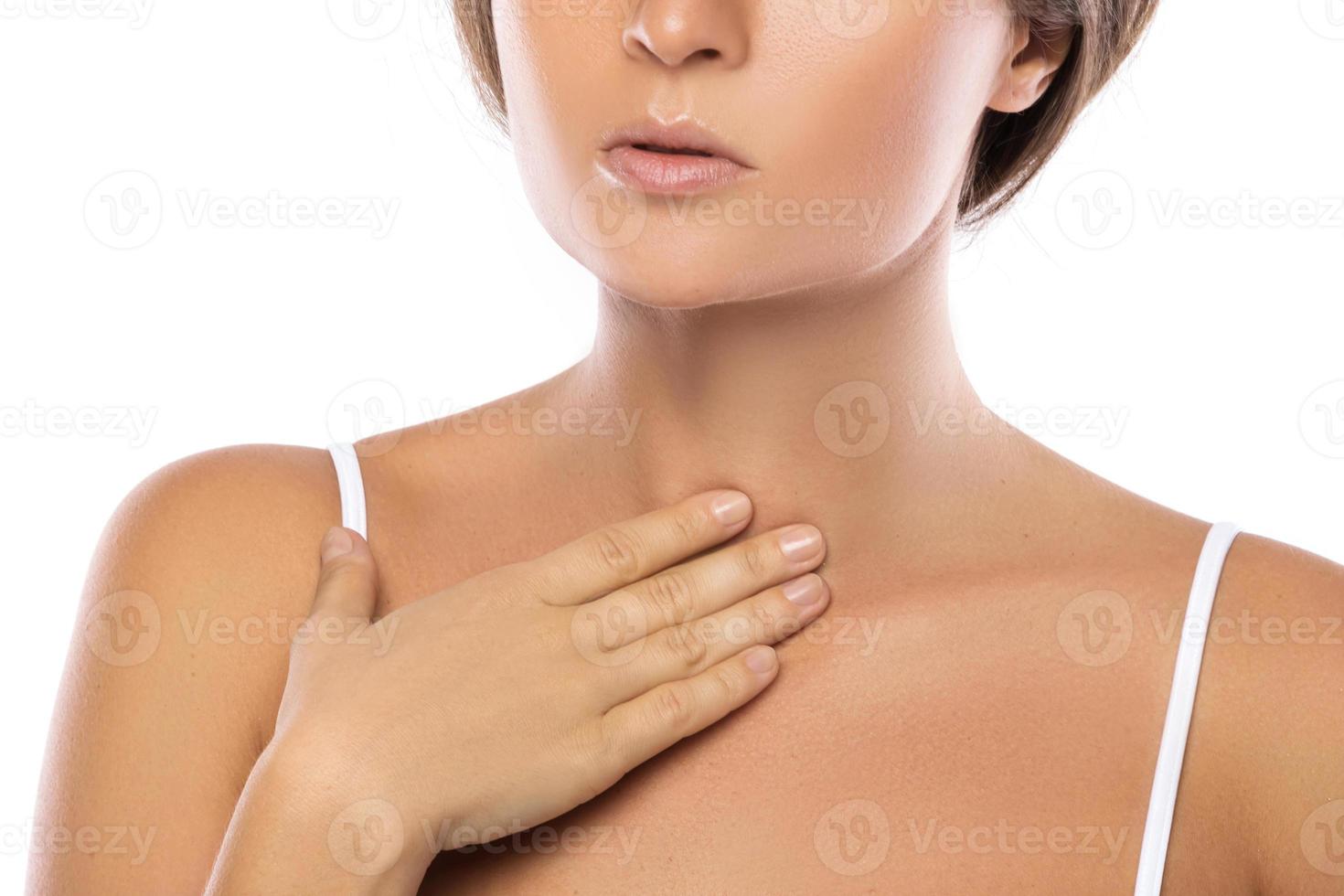 Woman with a pain in her throat photo