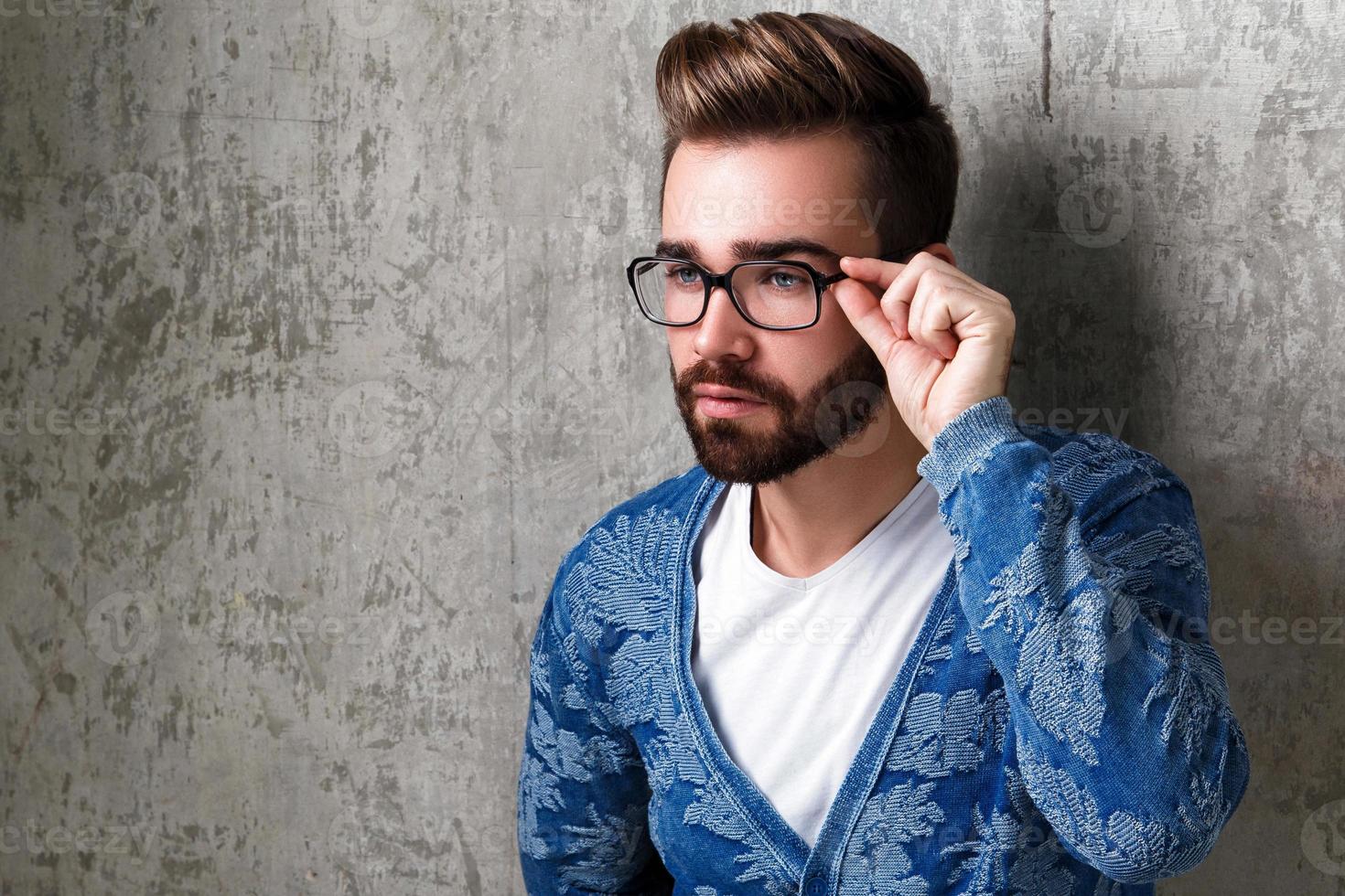 Handsome young bearded man wearing the eyeglasses photo