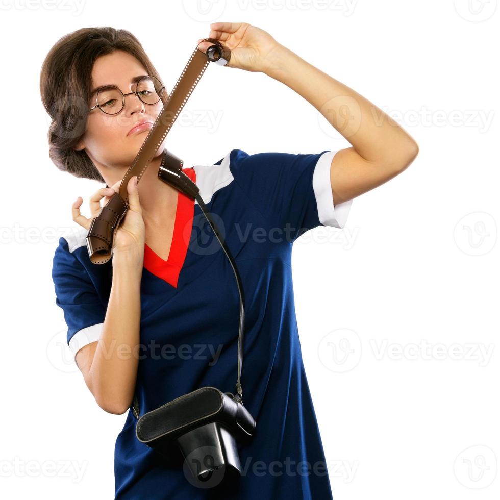 Woman in vintage look holding photographic film in her hands photo