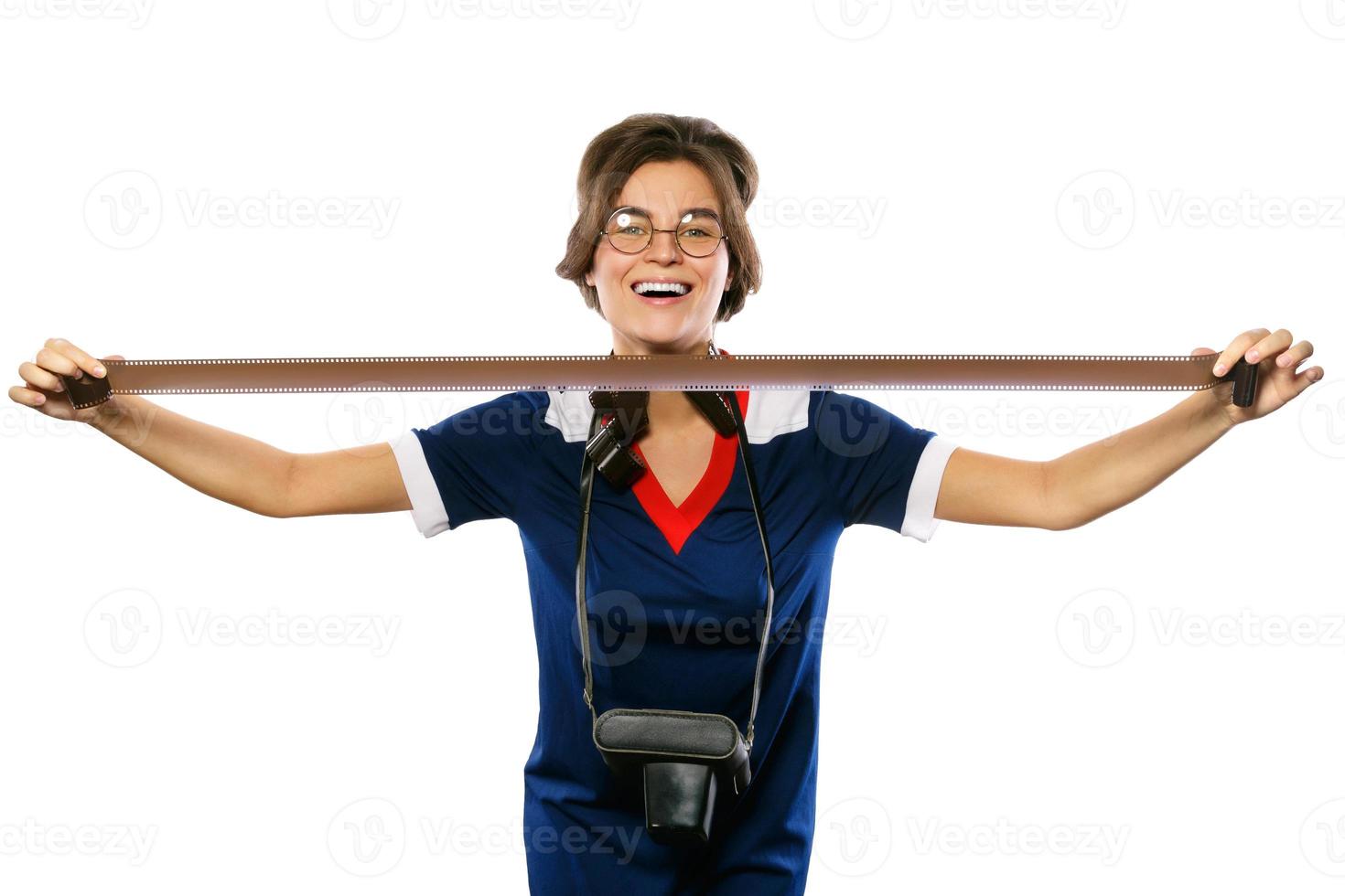 Woman in vintage look holding photographic film in her hands photo