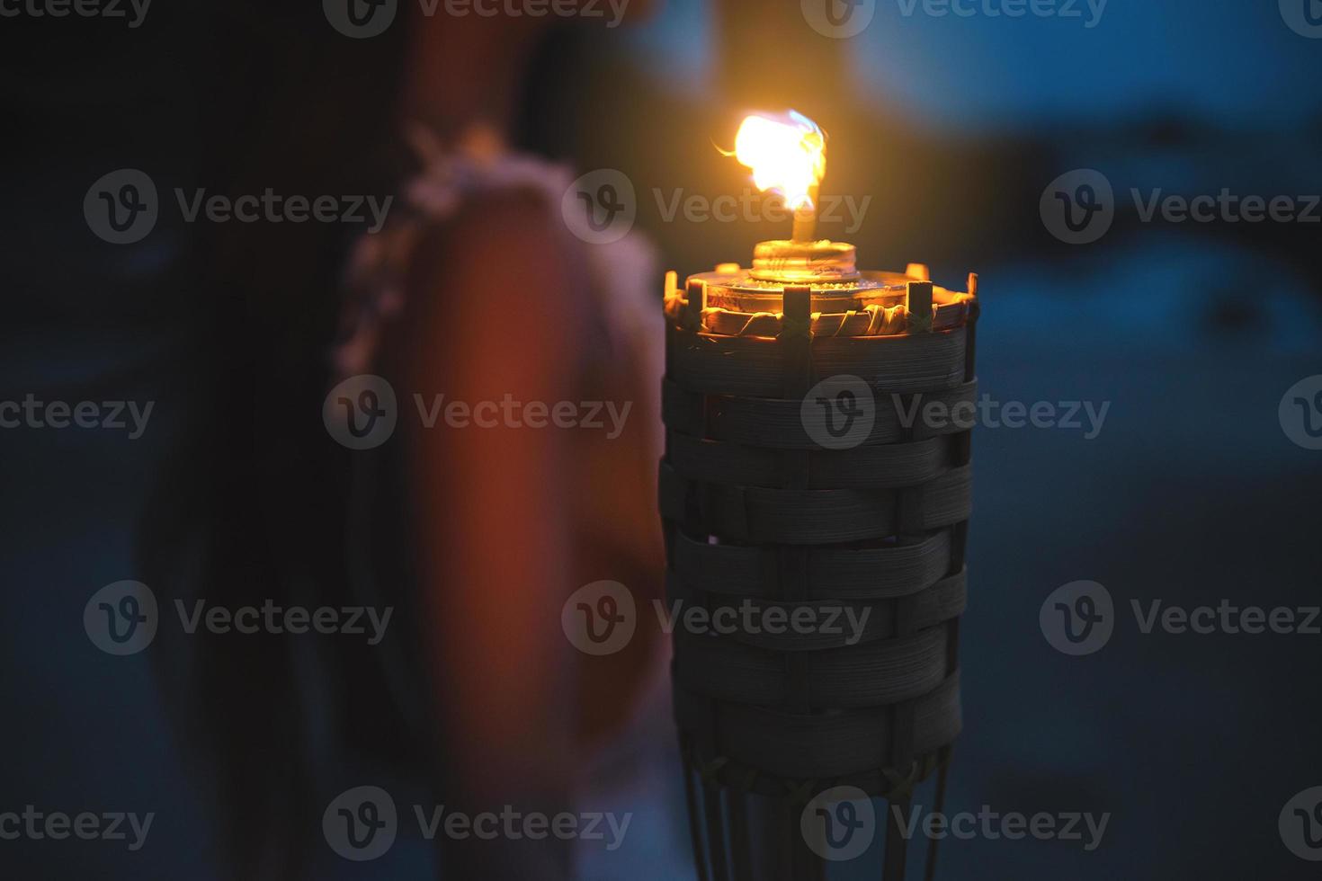 Close-up of bamboo torch light on the beach photo