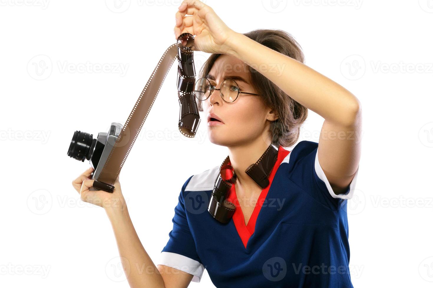 Woman in vintage look holding photographic film in her hands photo