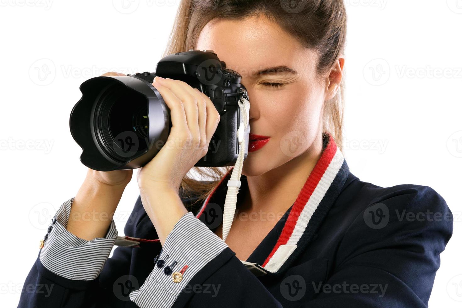 Woman photographer with a DSLR camera on white background photo