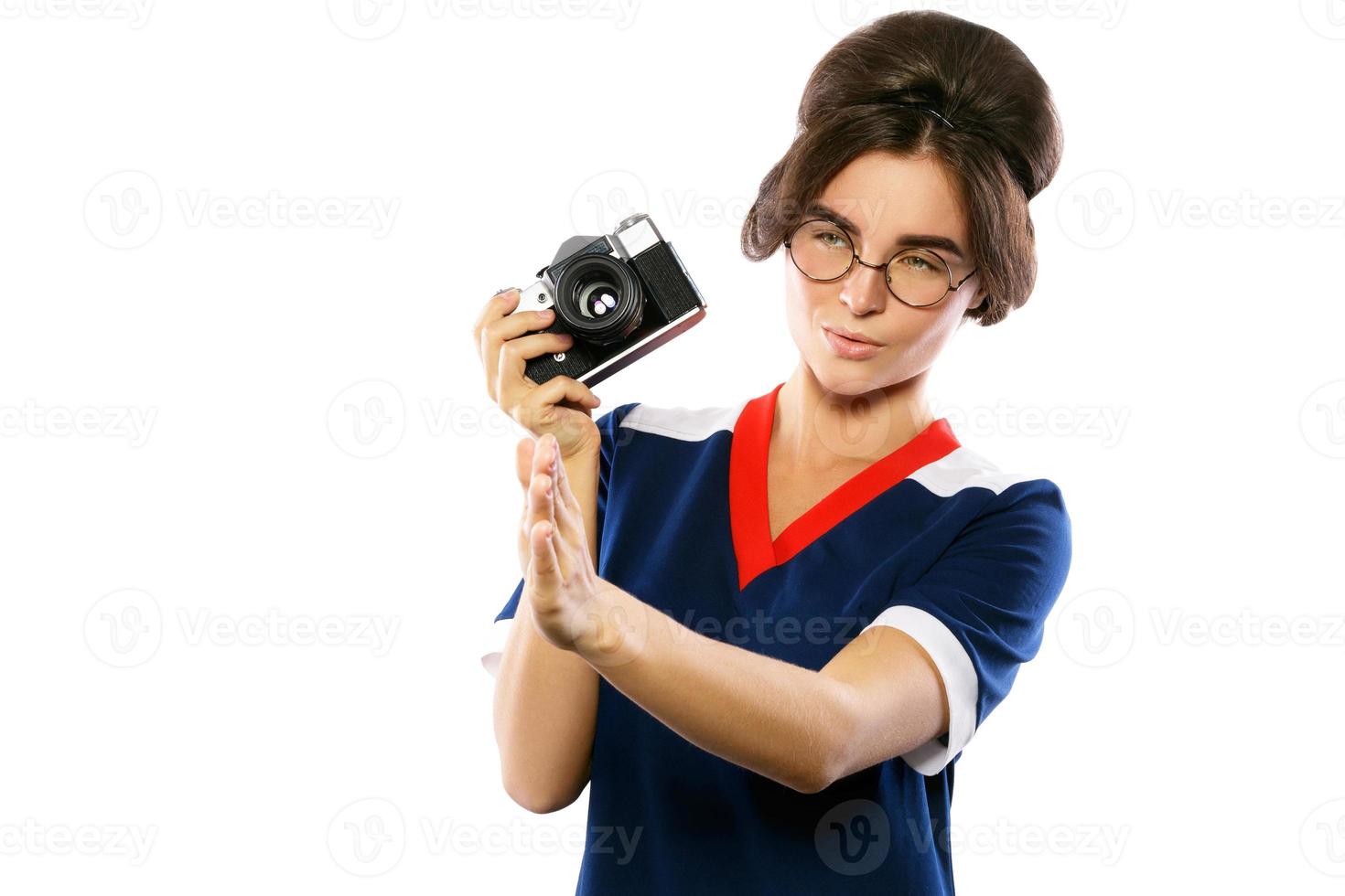 modelo de mujer con aspecto vintage sosteniendo una cámara retro en sus manos foto