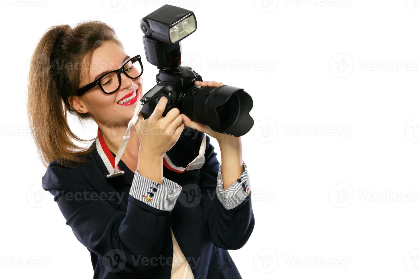 Woman photographer with a DSLR camera on white background photo