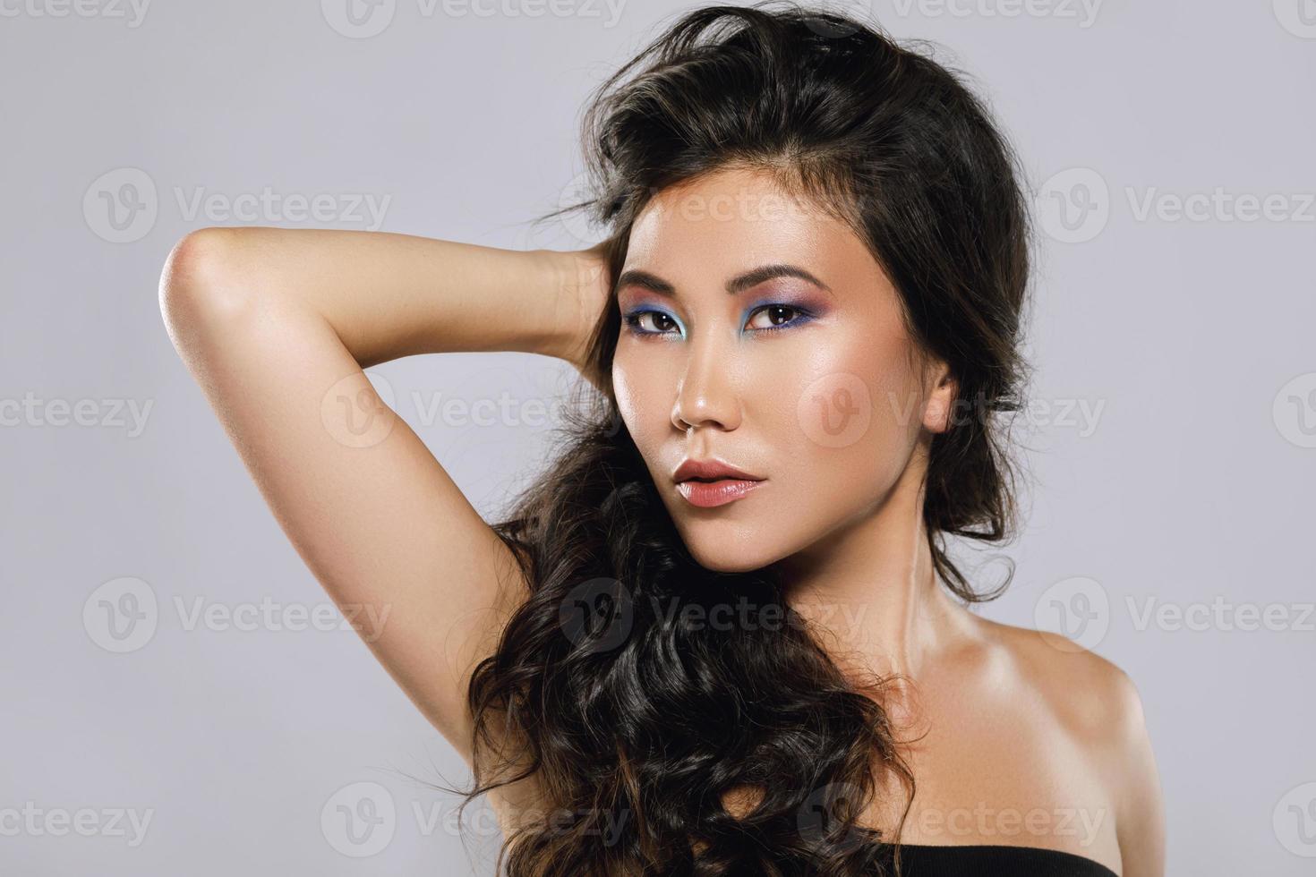 Young asian woman with a beautiful curly hair and make-up photo
