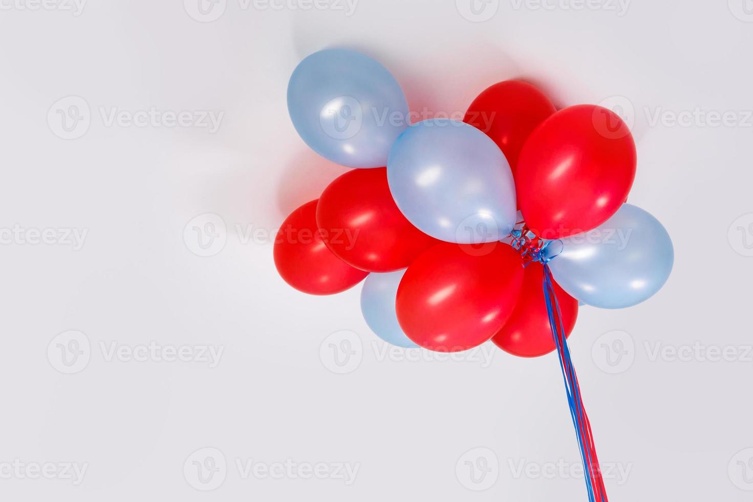 Heap of colorful balloons stuck under the ceiling photo