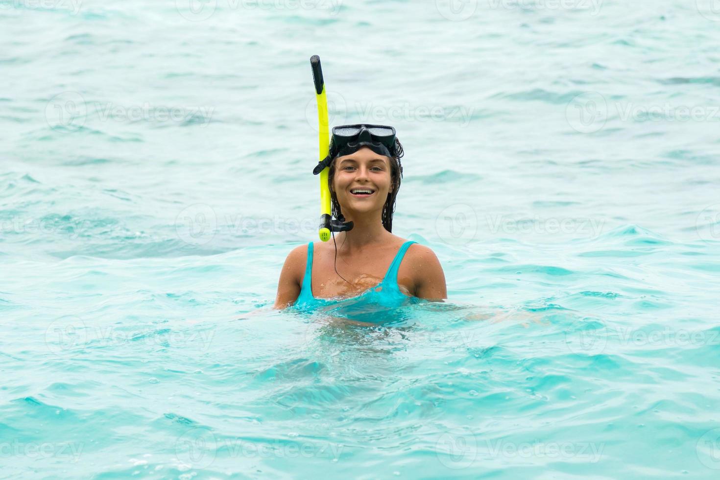 Woman in the sea during snorkeling in blue water photo