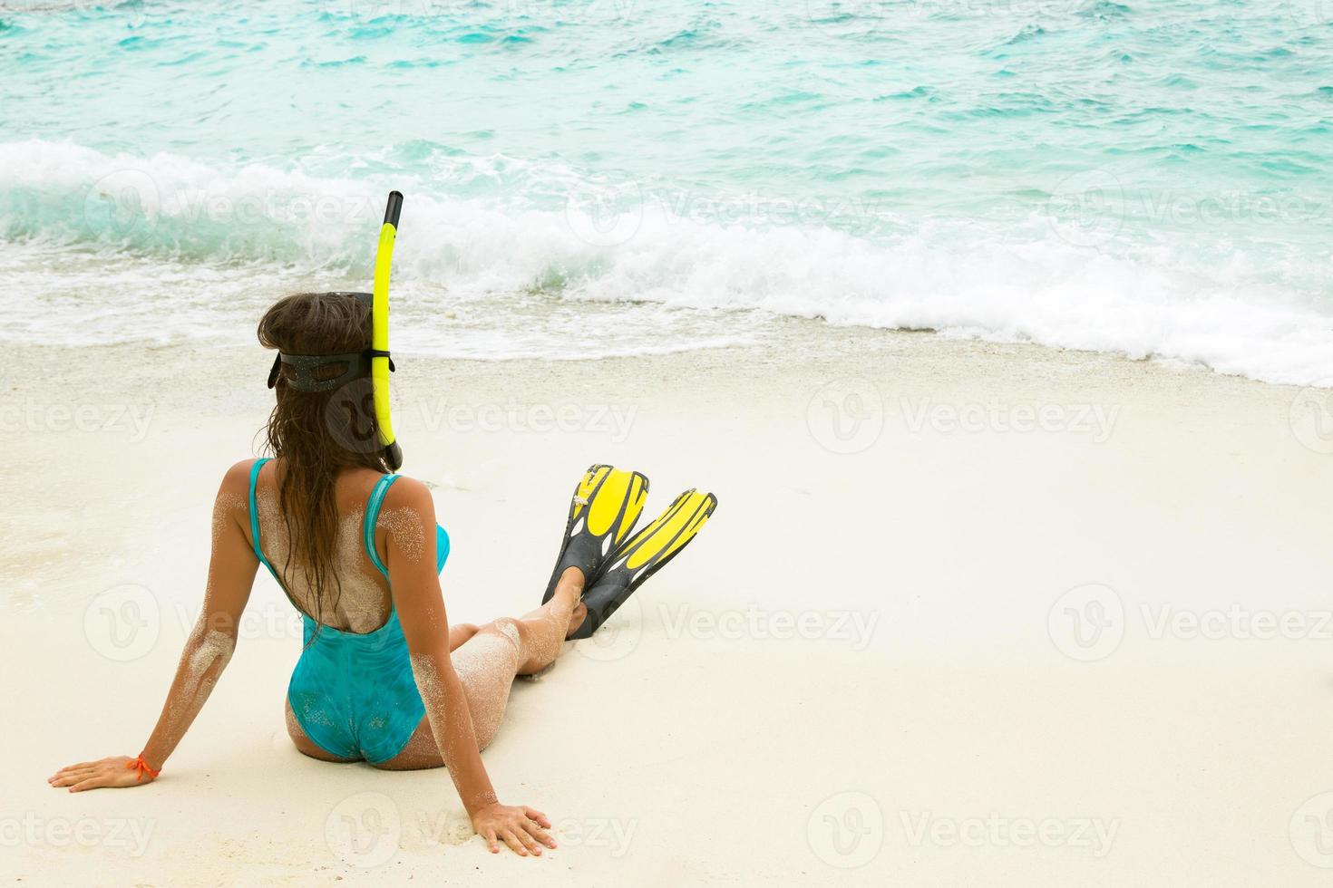 Beautiful young woman after snorkeling on the beach photo