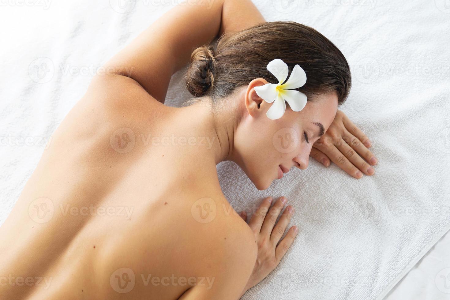 Woman is lying and relaxing after massage session photo