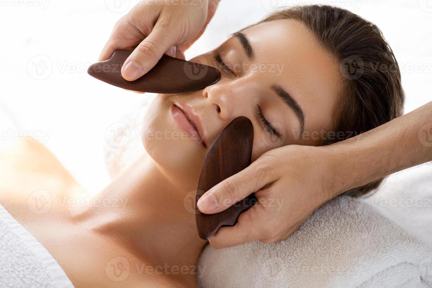 Woman during Chinese traditional massage - Gua Sha photo