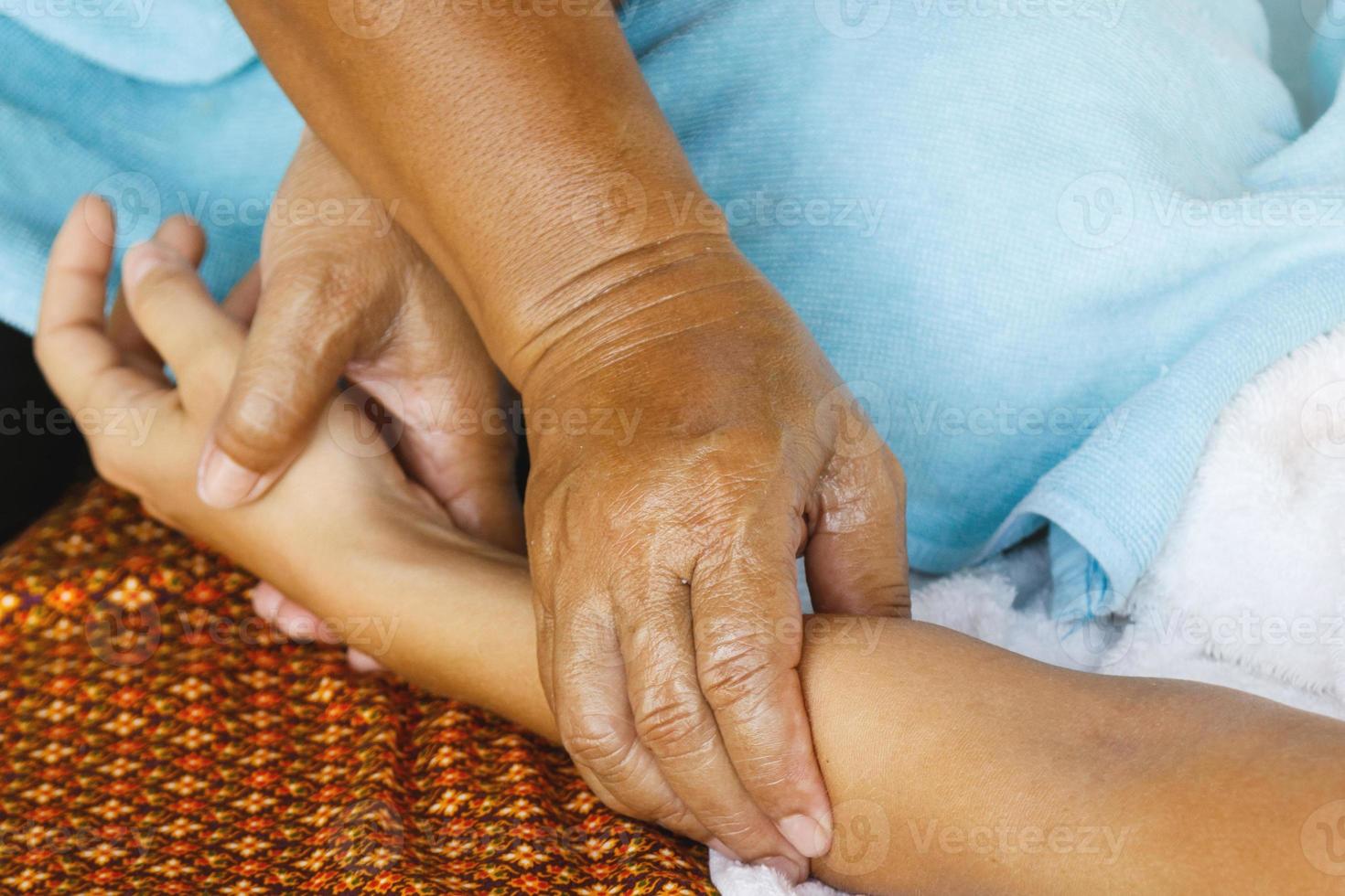 Closeup of female hand during traditional thai massage photo