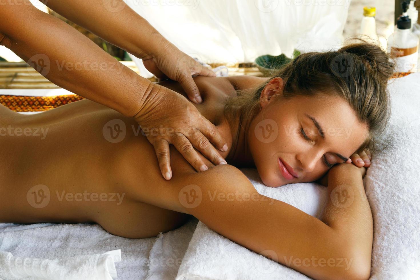 Young caucasian woman during traditional Thai massage photo