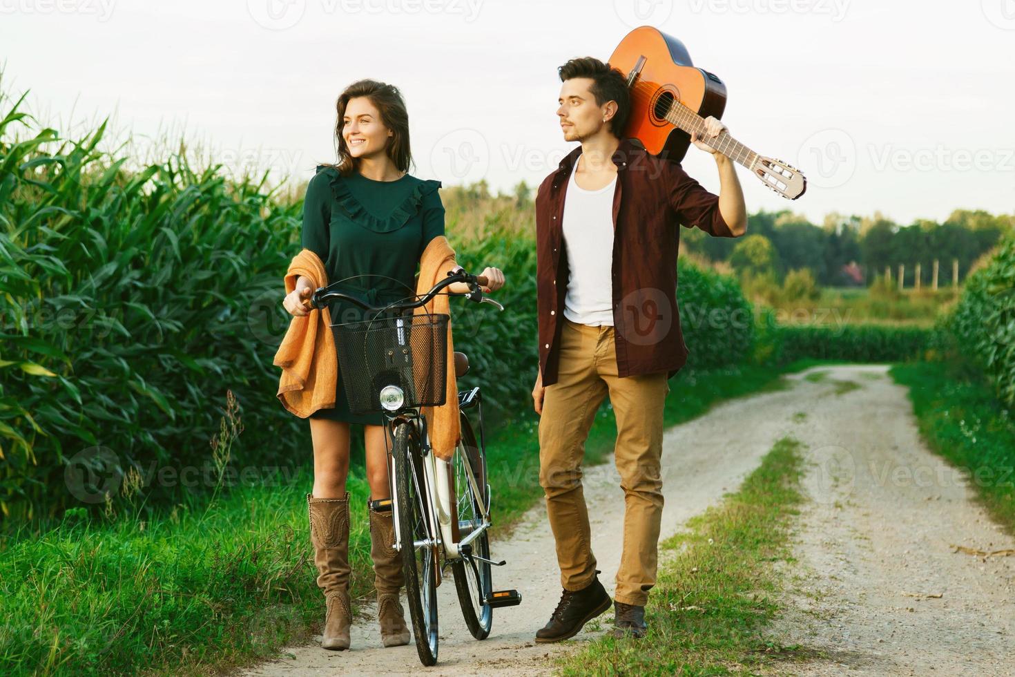 Young couple is walking by country road photo