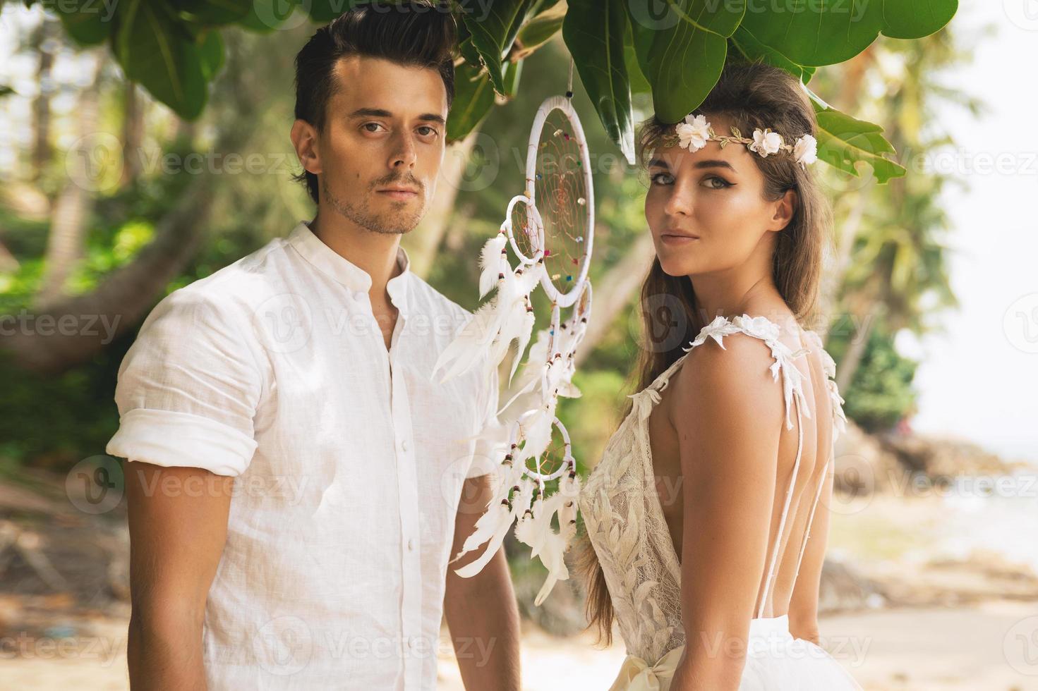 Just married couple is celebrating their wedding on the beach photo