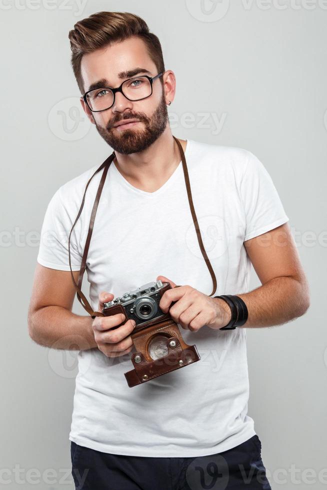 Photographer man with retro camera in studio photo