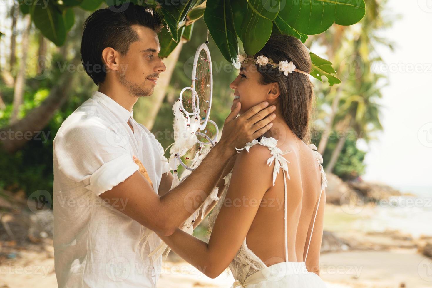 Just married couple is celebrating their wedding on the beach photo