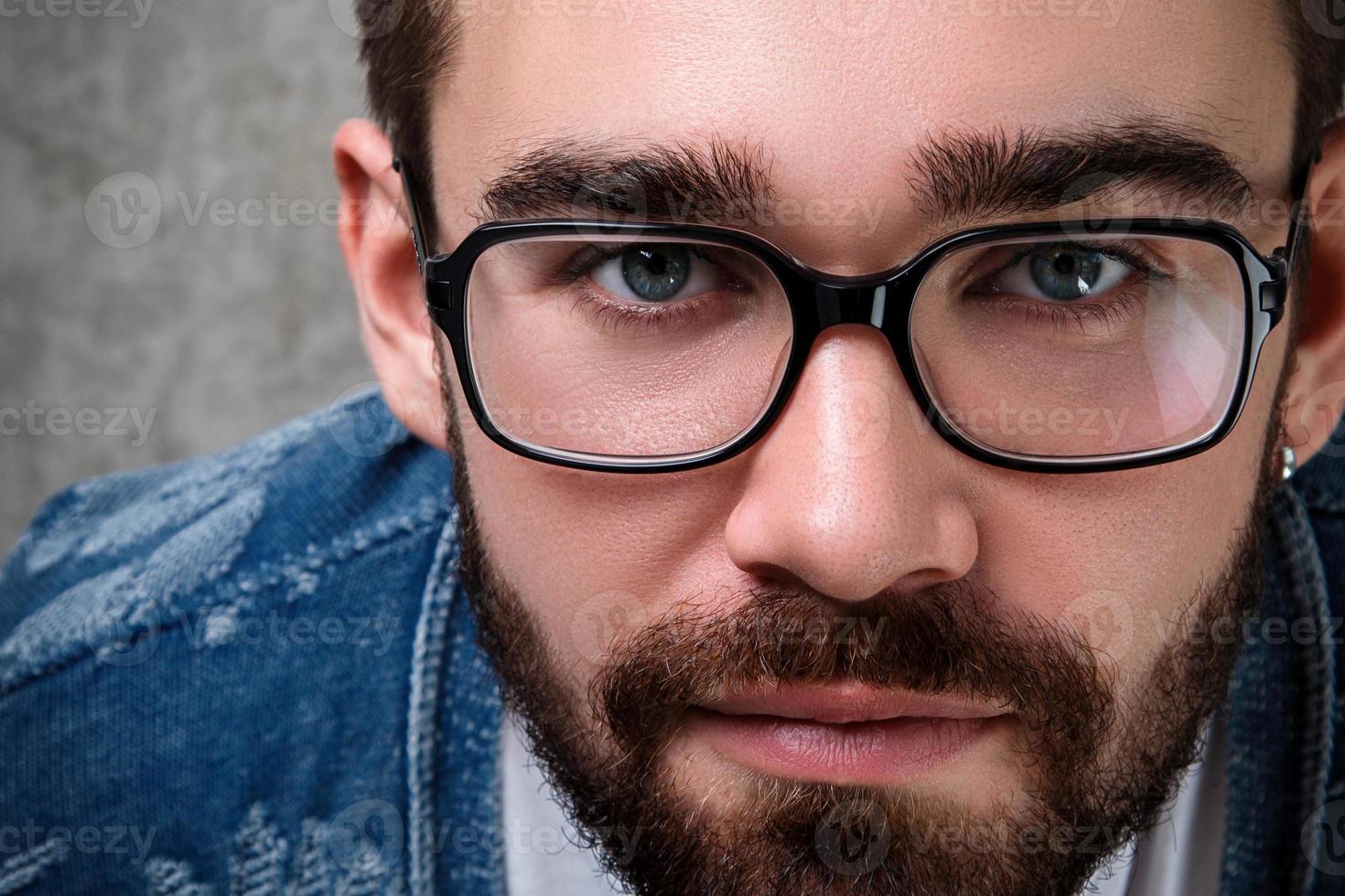 Handsome young bearded man wearing the eyeglasses photo