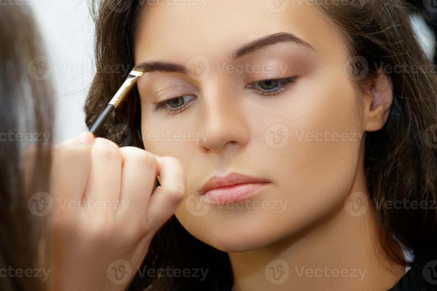 Model and makeup artist working before photoshoot photo