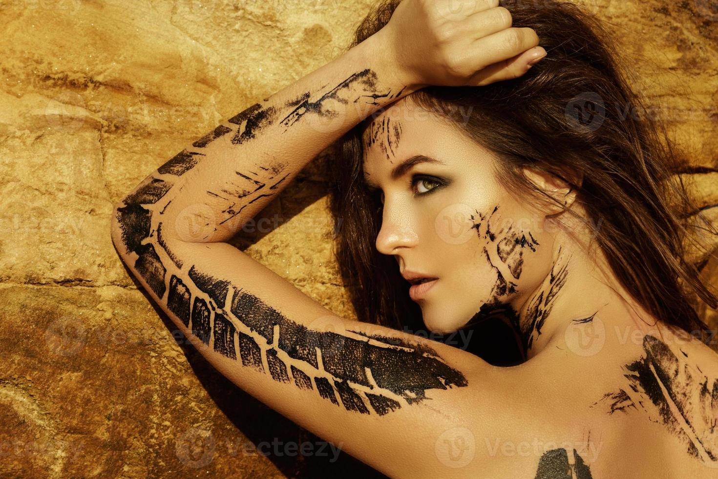 Beautiful woman with trace of car tire on her body photo