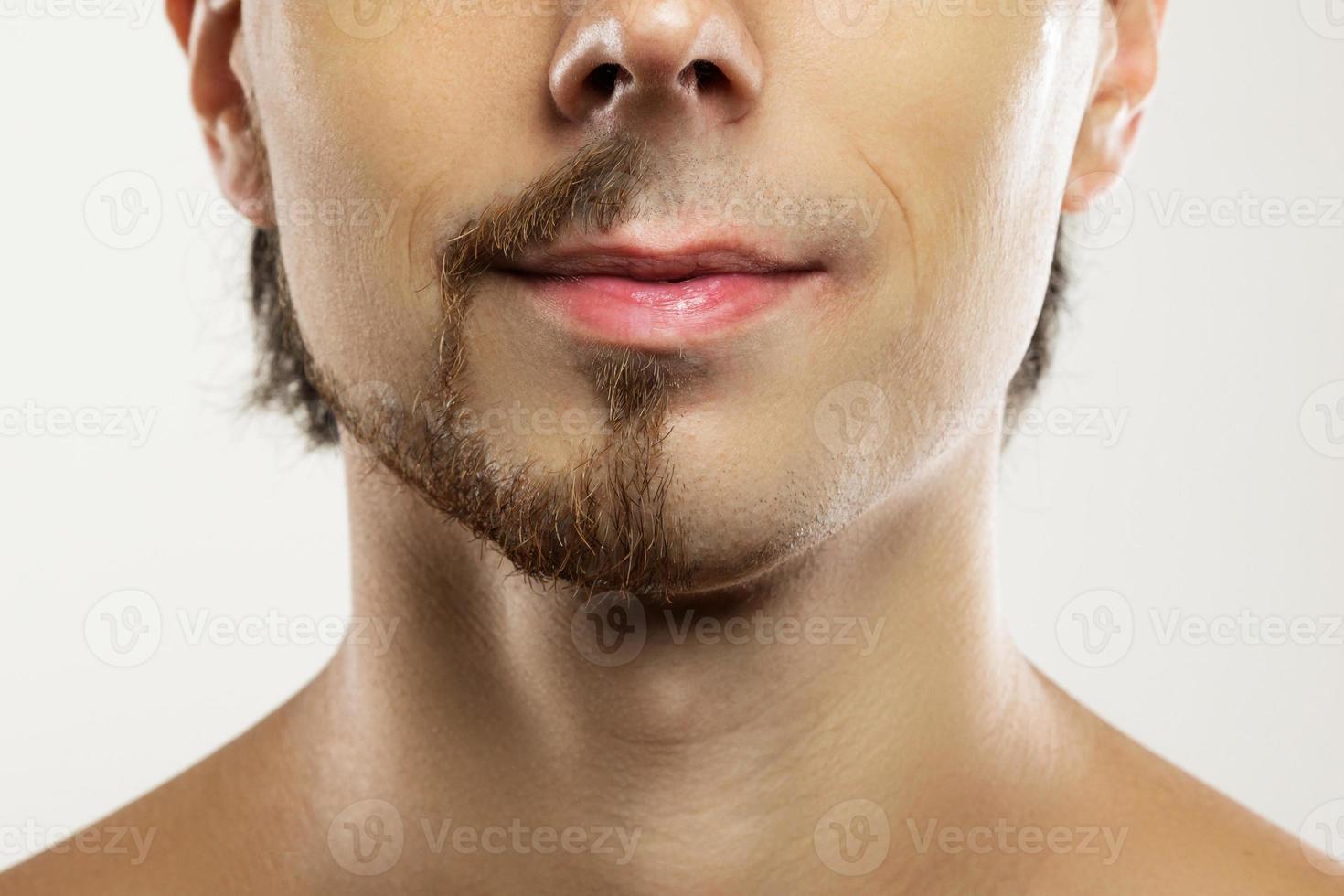 Man face with a partially shaved beard. photo