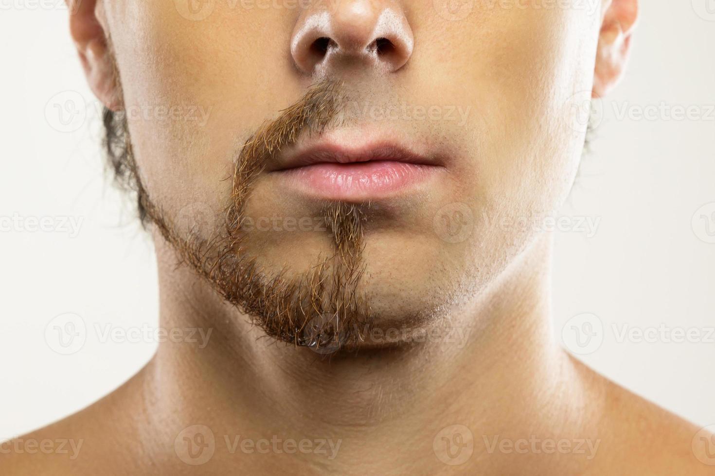 Man face with a partially shaved beard. photo