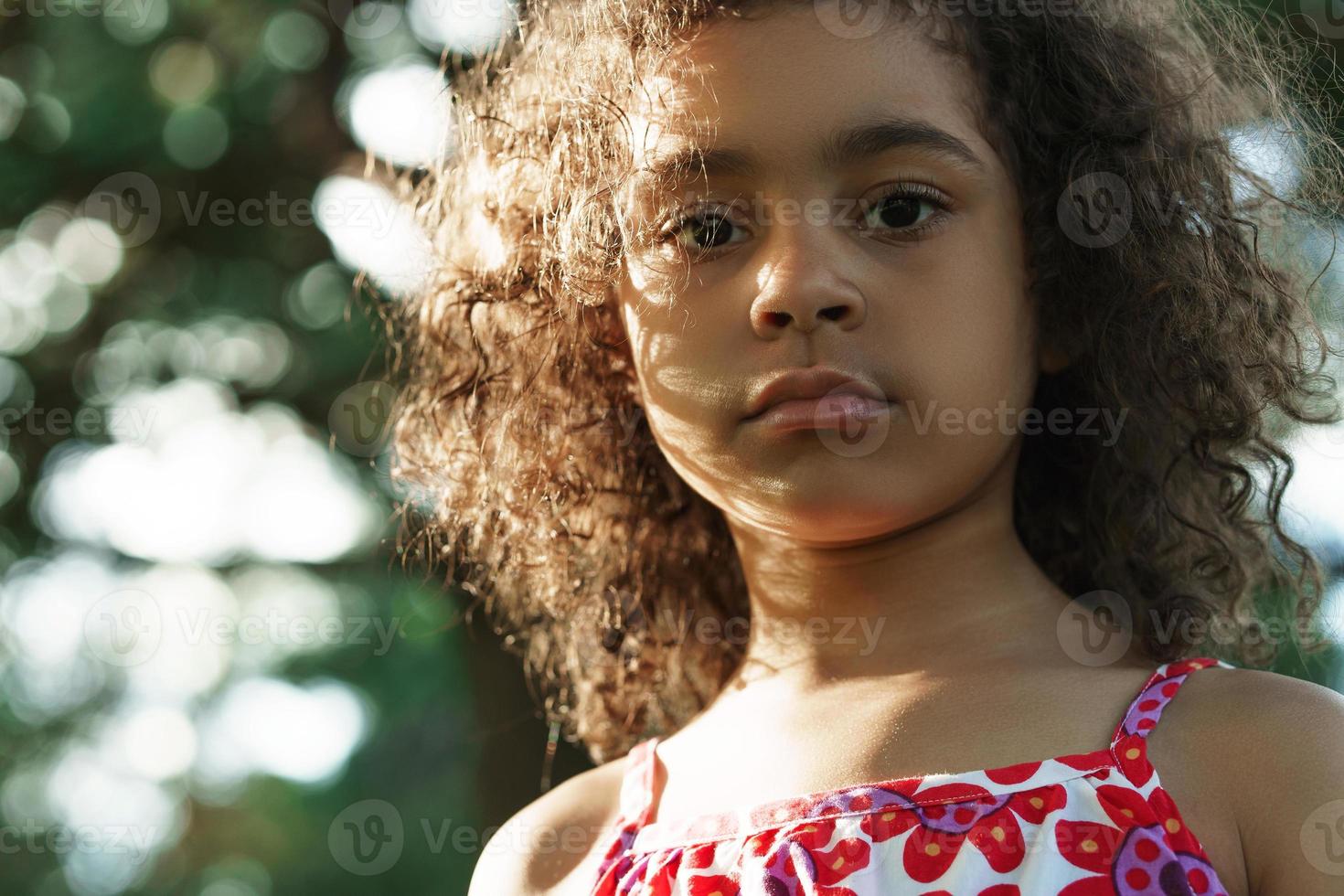 Portrait of serious black girl in a park photo