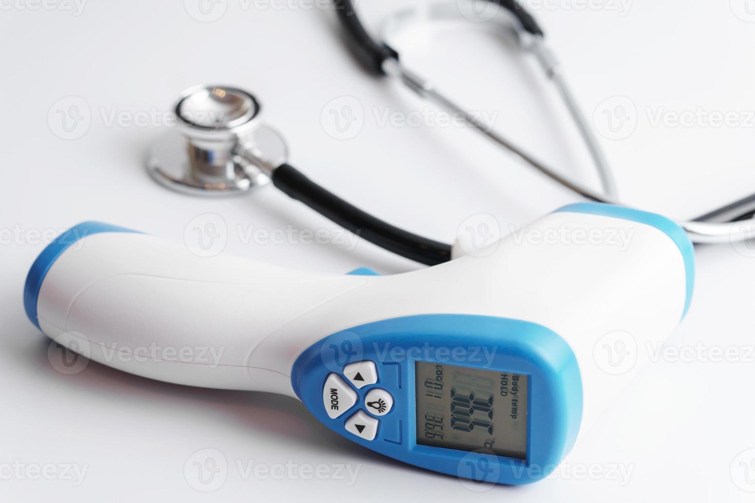 Close up of digital infrared thermometer and stethoscope photo