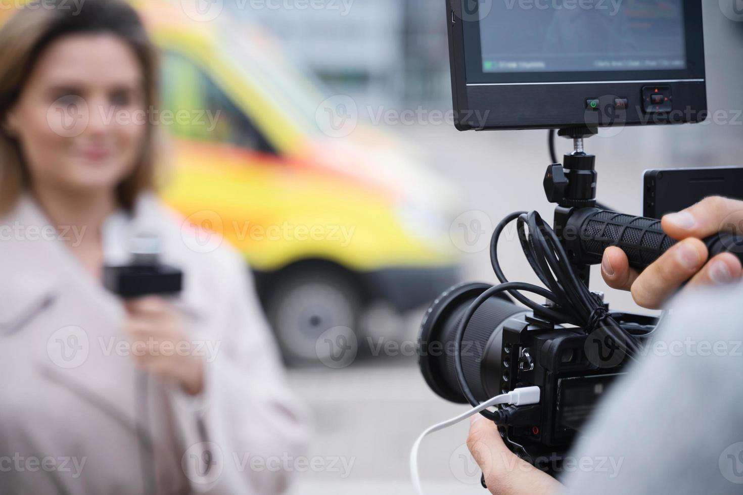 Cameraman is recording footage for TV news photo